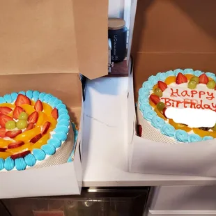 two birthday cakes in boxes