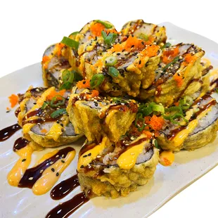 a plate of sushi with sauce