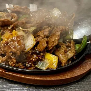 Impressive presentation that served with sizzling sound, but the beef was too well done &amp; on the tough side.
