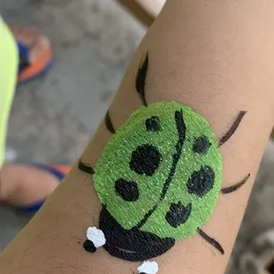 The one &amp; only Green Ladybug! From the face/arm painting station.. &amp; a super hairy toddler arm