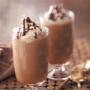 two glasses of coffee with whipped cream and chocolate