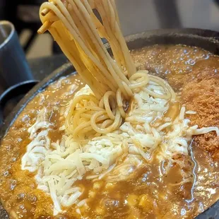 spaghetti being cooked in a skillet