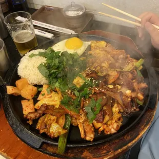 Cheolphan Nahkji Dupb'ap ($22.99) - rice w/ assorted veggies, spicy octopus, and egg on hot iron platter