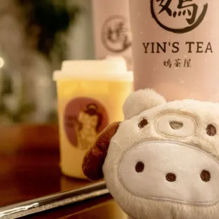 a cup of tea and a stuffed animal