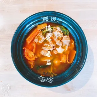 a bowl of soup with meat and vegetables