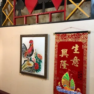 a rooster and a ship on the wall