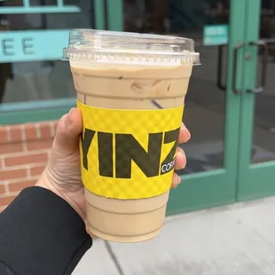 a hand holding a cup of coffee