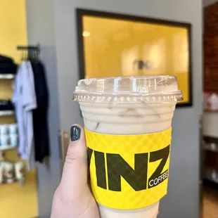 a hand holding a cup of coffee
