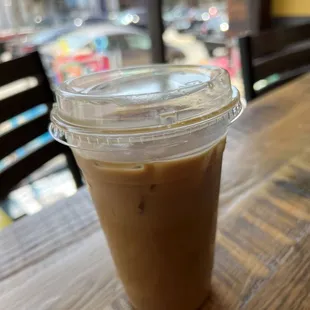 Iced purple rain latte with oat milk in a large cup