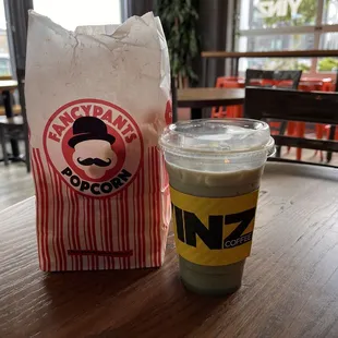 a paper bag and a cup of coffee