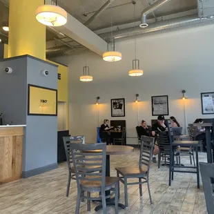 people sitting at tables in a coffee shop
