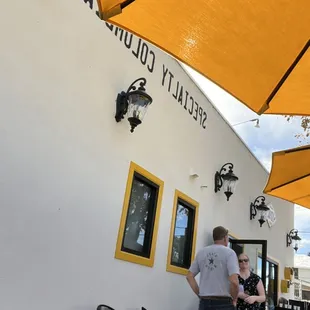 Outdoor seating, iconic yellow umbrellas to let you know where the coffee shop is