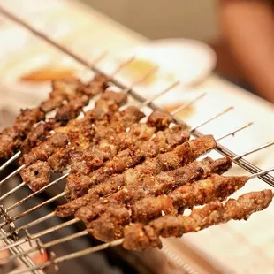 the meat being cooked on the grill