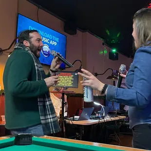 a man and a woman playing pool