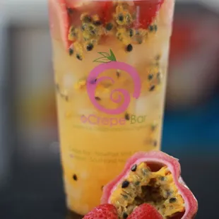 a glass of fruit smoothie with strawberries and raspberries