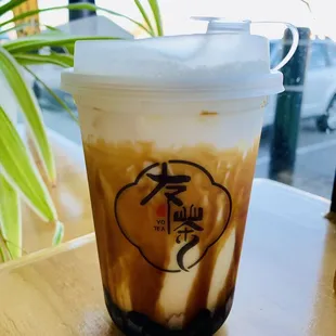 a cup of iced coffee on a table