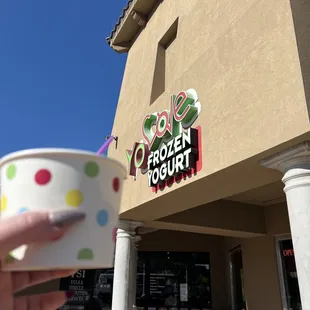 a hand holding a cup