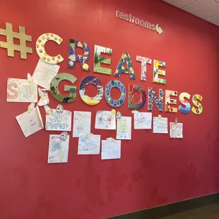 a red wall with the words create goodies written on it