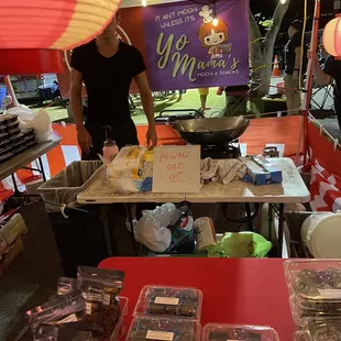 a man standing behind a table