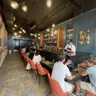 a group of people sitting at a bar