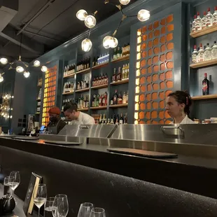 a bar with people sitting at the bar