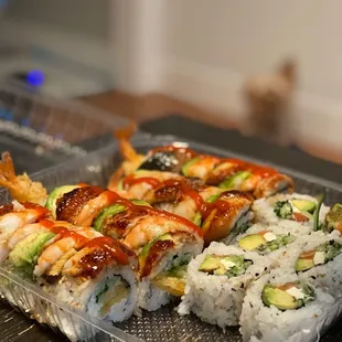 a plastic container with sushi on it