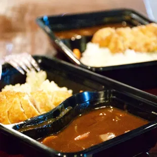 two trays of food on a table