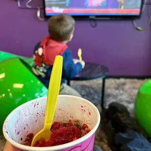 a person holding a cup of yogurt