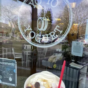 a hand holding a cup of yogurt