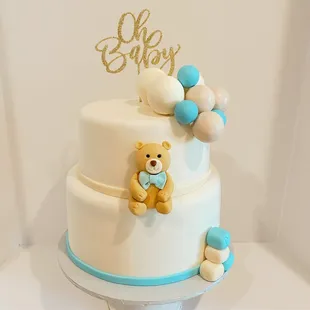 a cake with a teddy bear on top