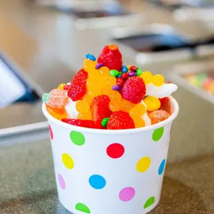 a cup of ice cream with fruit on top