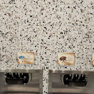 two soda dispensers with labels on them