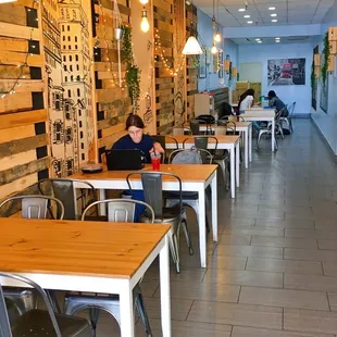 a woman sitting at a table in a restaurant