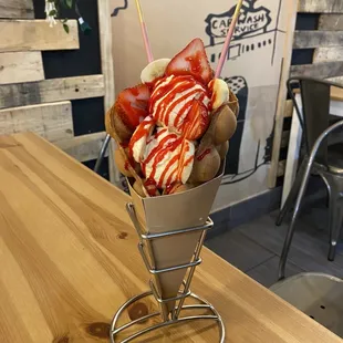 a cone of ice cream and strawberries