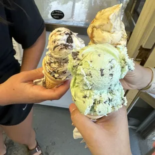 two people holding ice cream cones