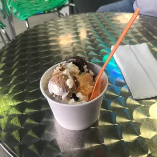 a bowl of ice cream with fruit and nuts