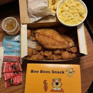 Inside the seafood platter box.  Sides are Mac &amp; Cheese and fries.