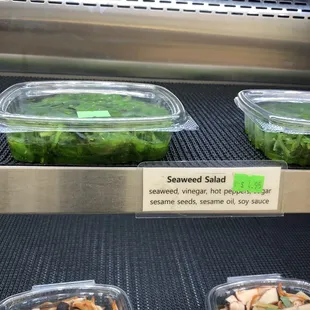 three containers of vegetables on a conveyor belt