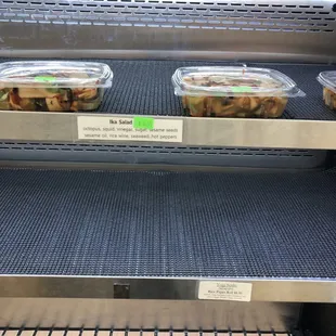 two trays of food on a conveyor belt