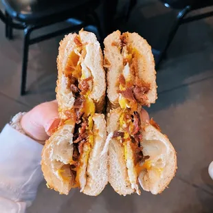 a person holding a sandwich