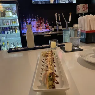 a plate of sushi and a glass of water