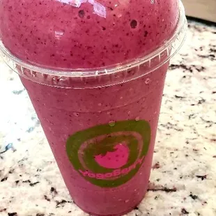 a smoothie in a plastic cup