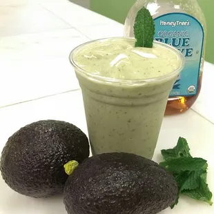 two avocados and a drink