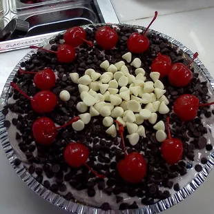 a chocolate cake with cherries and chocolate chips