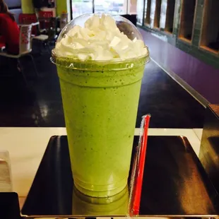 a green smoothie with whipped cream