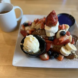 Delicious French toast with fruit and ube on the side.