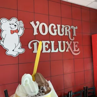 a hand holding a cup of yogurt