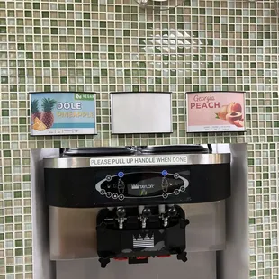 a yogurt machine in front of a sign