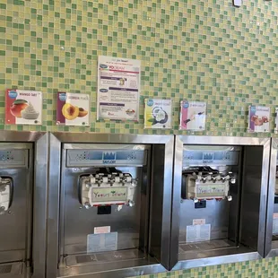 a row of frozen yogurt machines