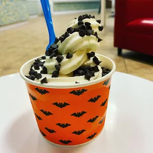 a cup of ice cream with chocolate sprinkles